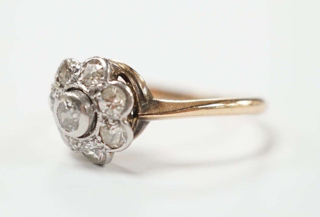 A yellow metal eight stone diamond cluster ring, size N